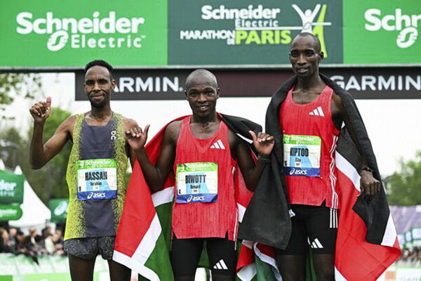(From L) Second-placed Djibouti's Ibrahim Hassan, winner Kenya's Benard Biwott and third-placed Kenya's Sila Kiptoo pose after crossing the finish line in the men's Paris Marathon, in Paris, on April 13, 2025. (Photo by Bertrand GUAY / AFP)